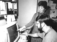 Photograph of scientists 
comparing fossil shapes on a computer screen